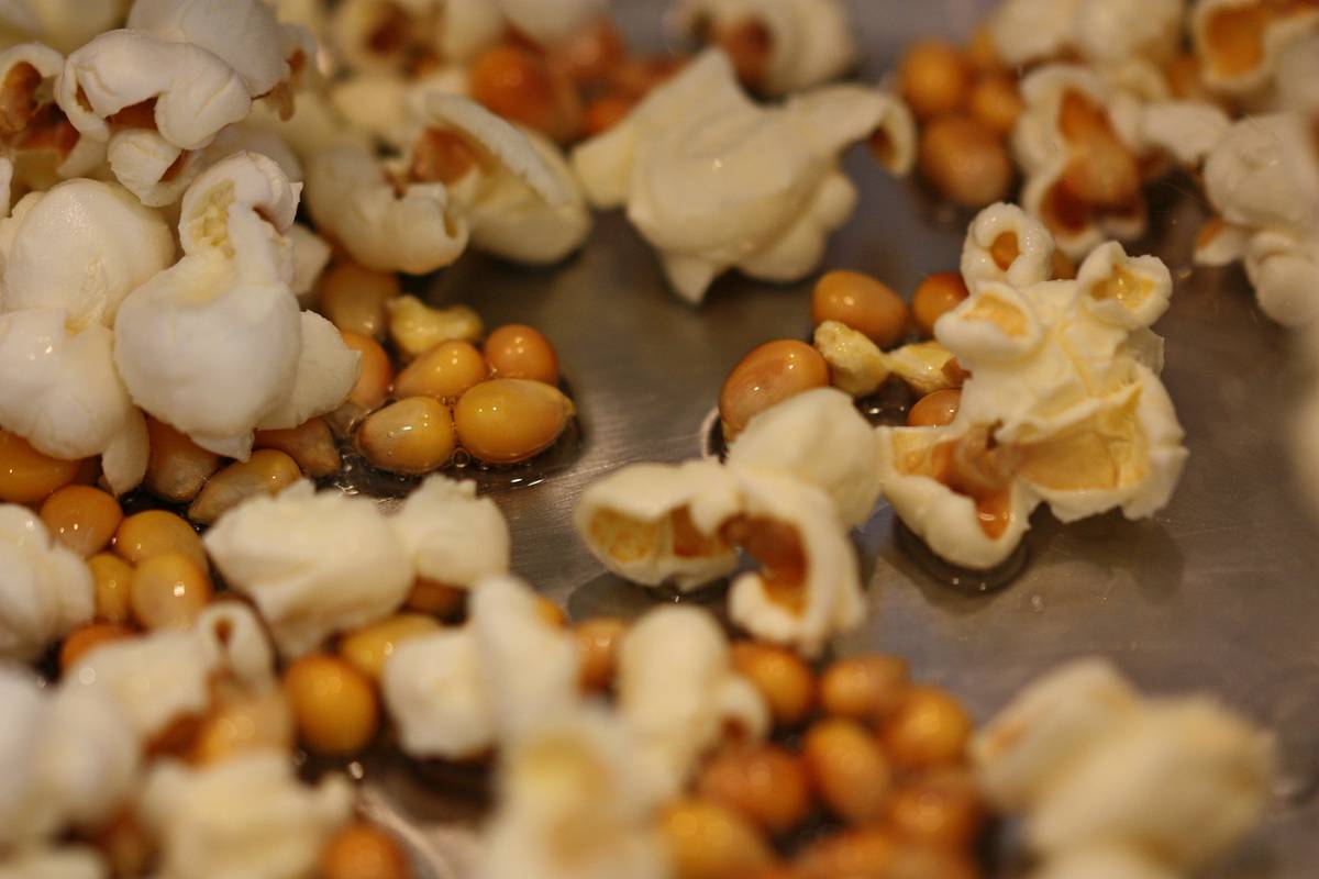 Step-by-step movie night popcorn maker instructions showing oil and kernel measurement